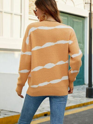 a woman is walking down the street wearing a sweater