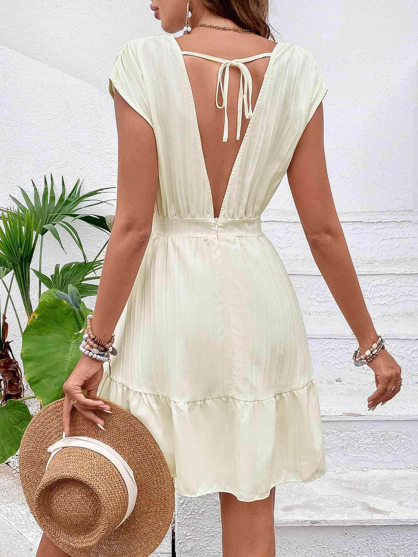 a woman wearing a white dress and a straw hat