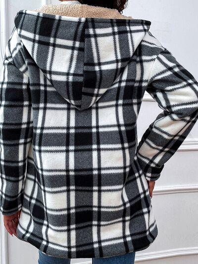 a woman wearing a black and white plaid coat