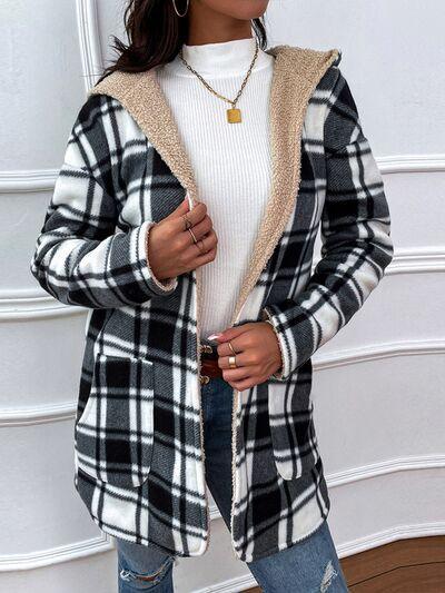 a woman wearing a black and white plaid jacket