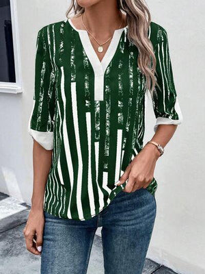 a woman wearing a green and white striped shirt