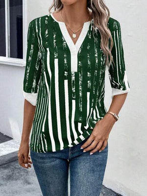 a woman wearing a green and white striped top