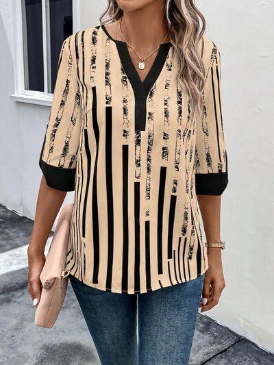 a woman wearing a black and white striped top