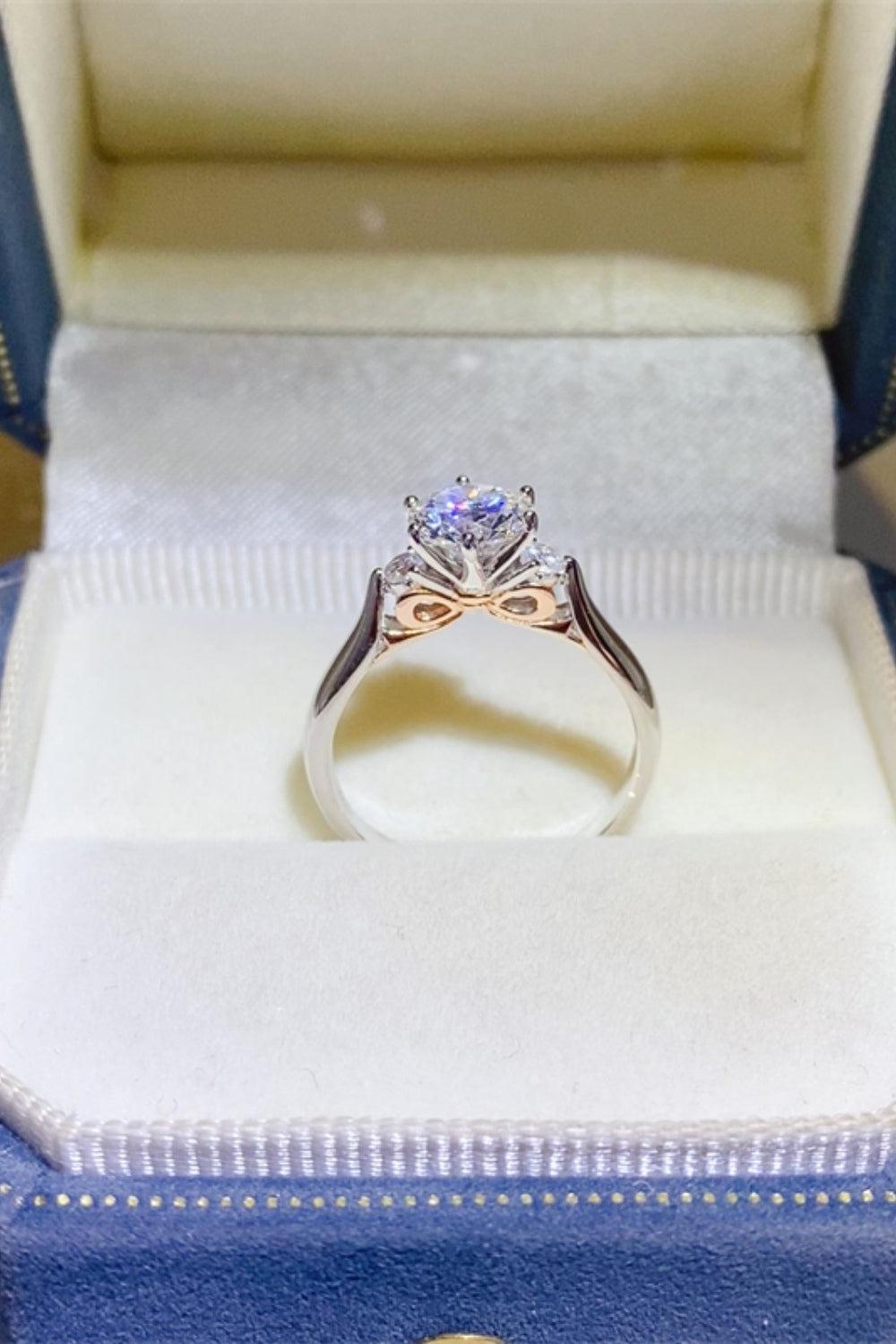 a ring in a blue box with a white diamond
