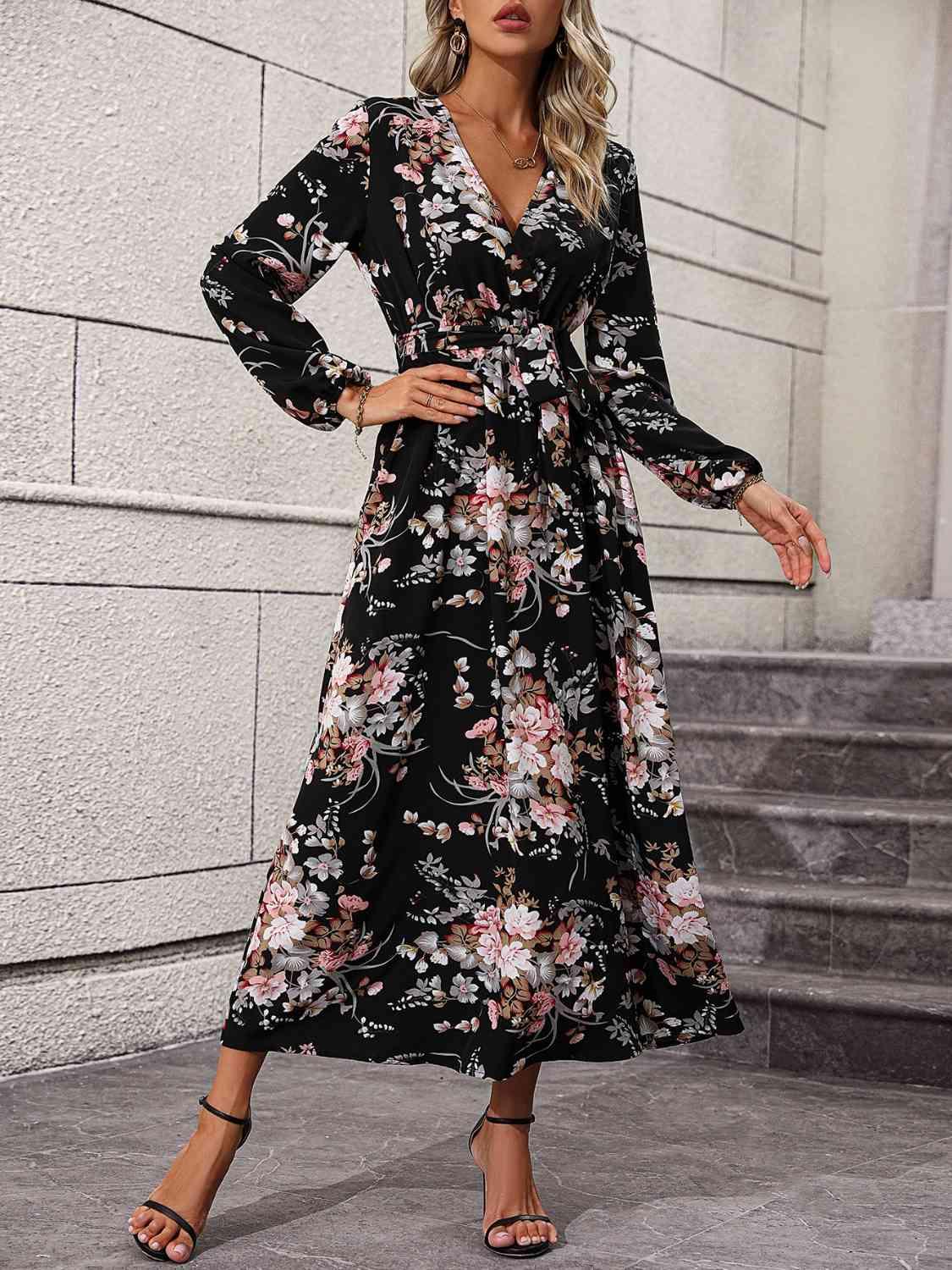 a woman wearing a black floral print dress