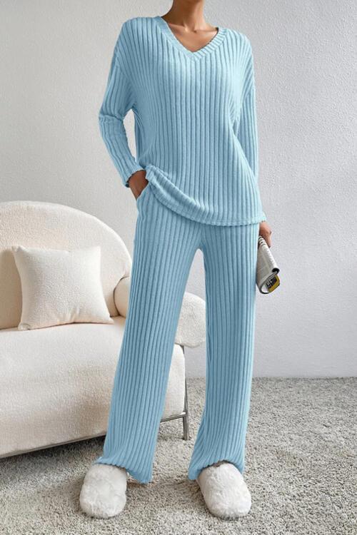 a woman wearing a blue sweater and pants