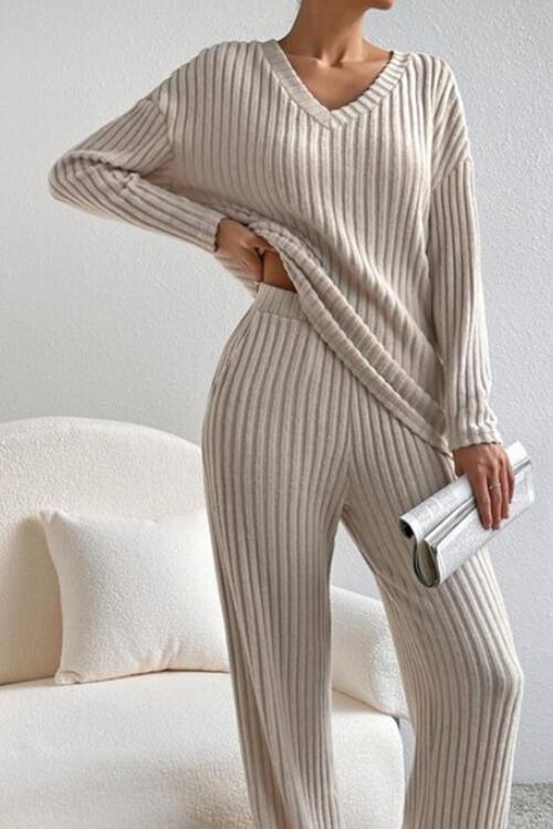 a woman in a sweater and pants posing for a picture