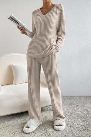 a woman standing in a living room holding a hair dryer