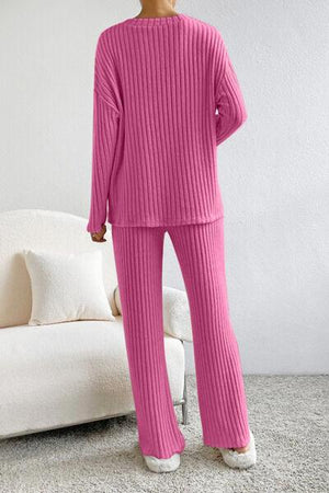 a woman in a pink sweater and pants