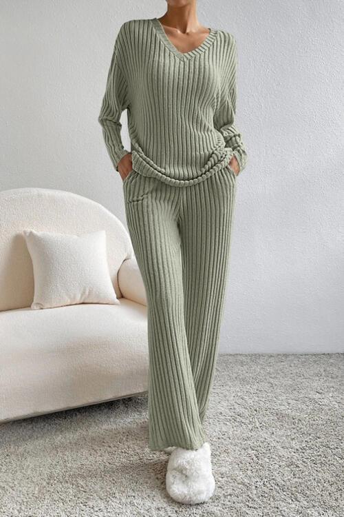 a woman wearing a green sweater and pants