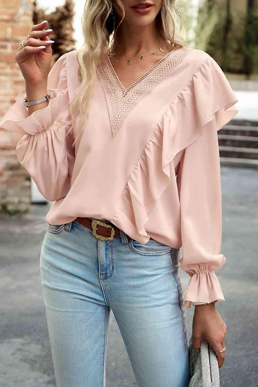 a woman in a pink top smoking a cigarette