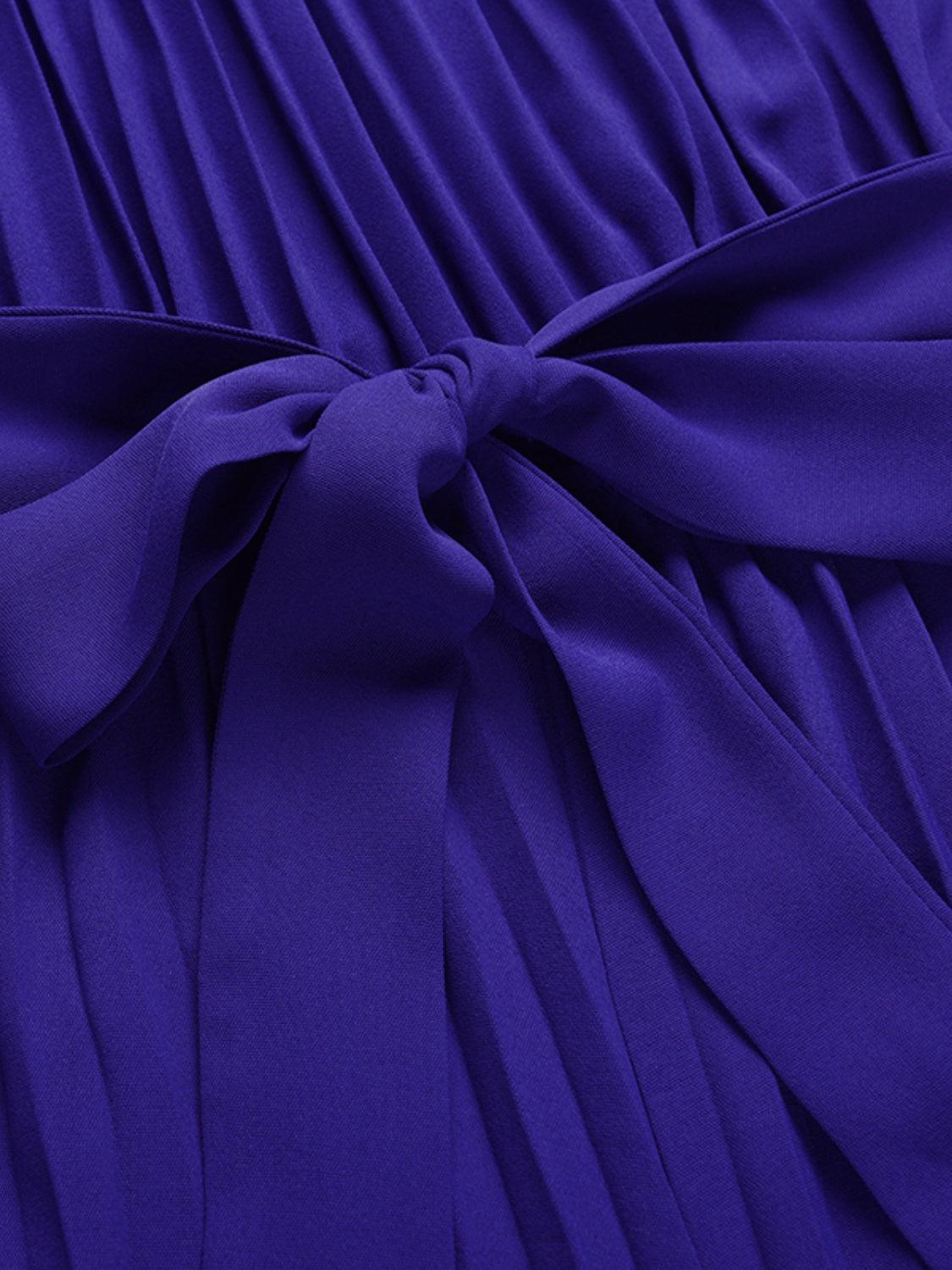 a close up of a purple dress with a bow