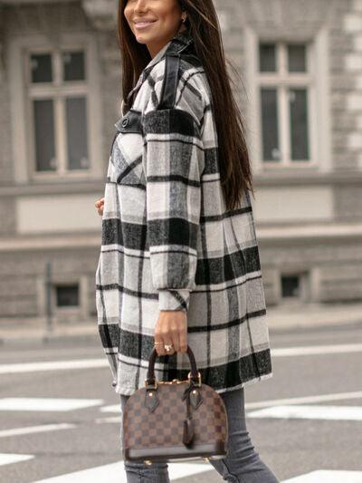 a woman is walking across the street with a suitcase