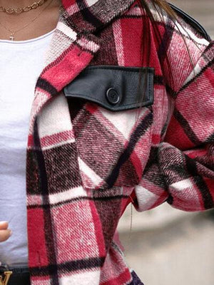 a woman wearing a red and black plaid coat