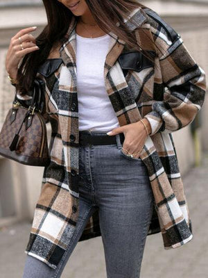 a woman wearing a plaid coat and jeans