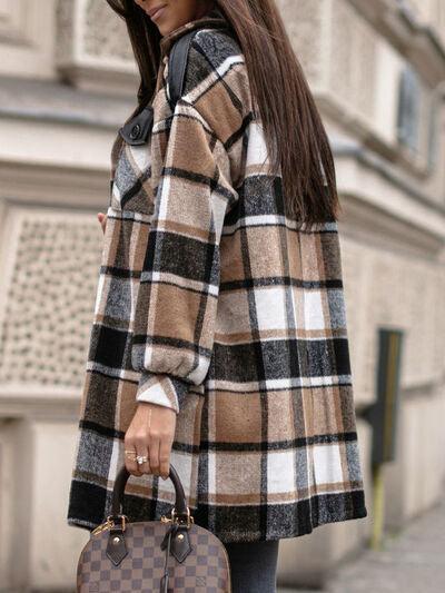 a woman in a plaid coat carrying a louis vuitton bag