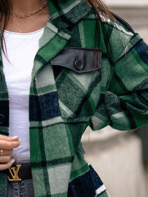 a woman wearing a green and black checkered coat