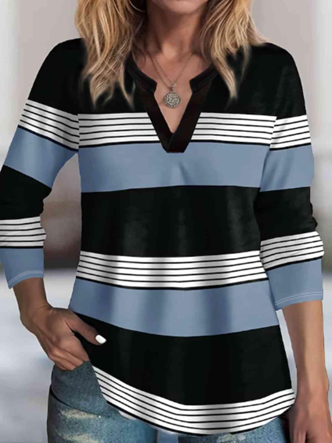 a woman wearing a black and blue striped shirt