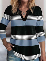 a woman wearing a black and blue striped shirt