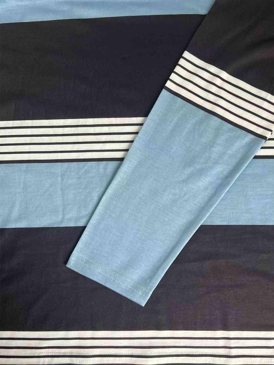 a blue and black bed spread with white and black stripes