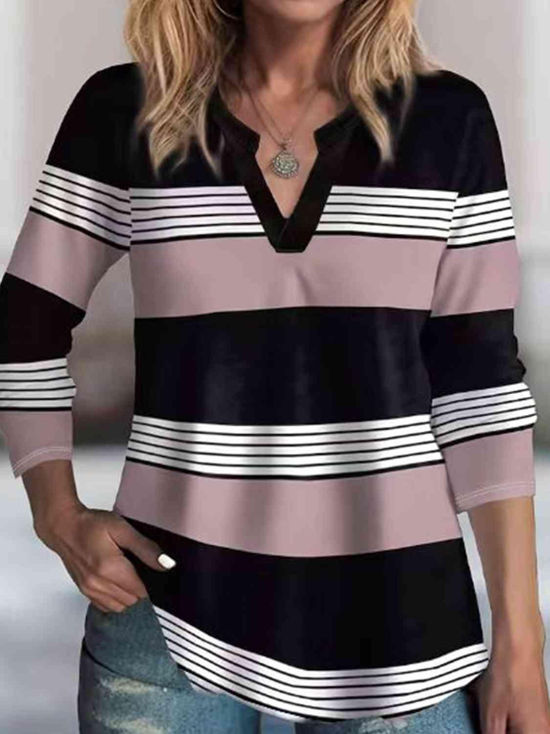 a woman wearing a black and white striped top