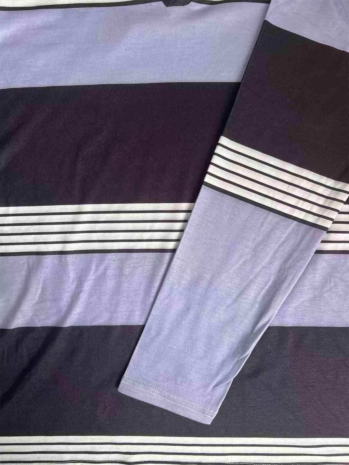 a bed with a purple and black striped comforter