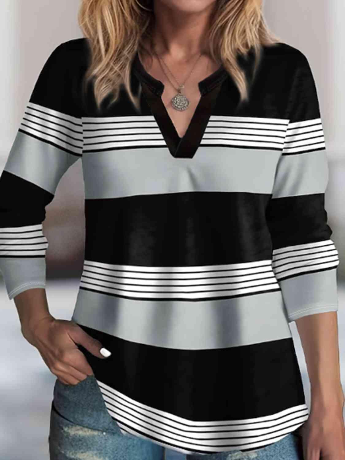 a woman wearing a black and white striped shirt