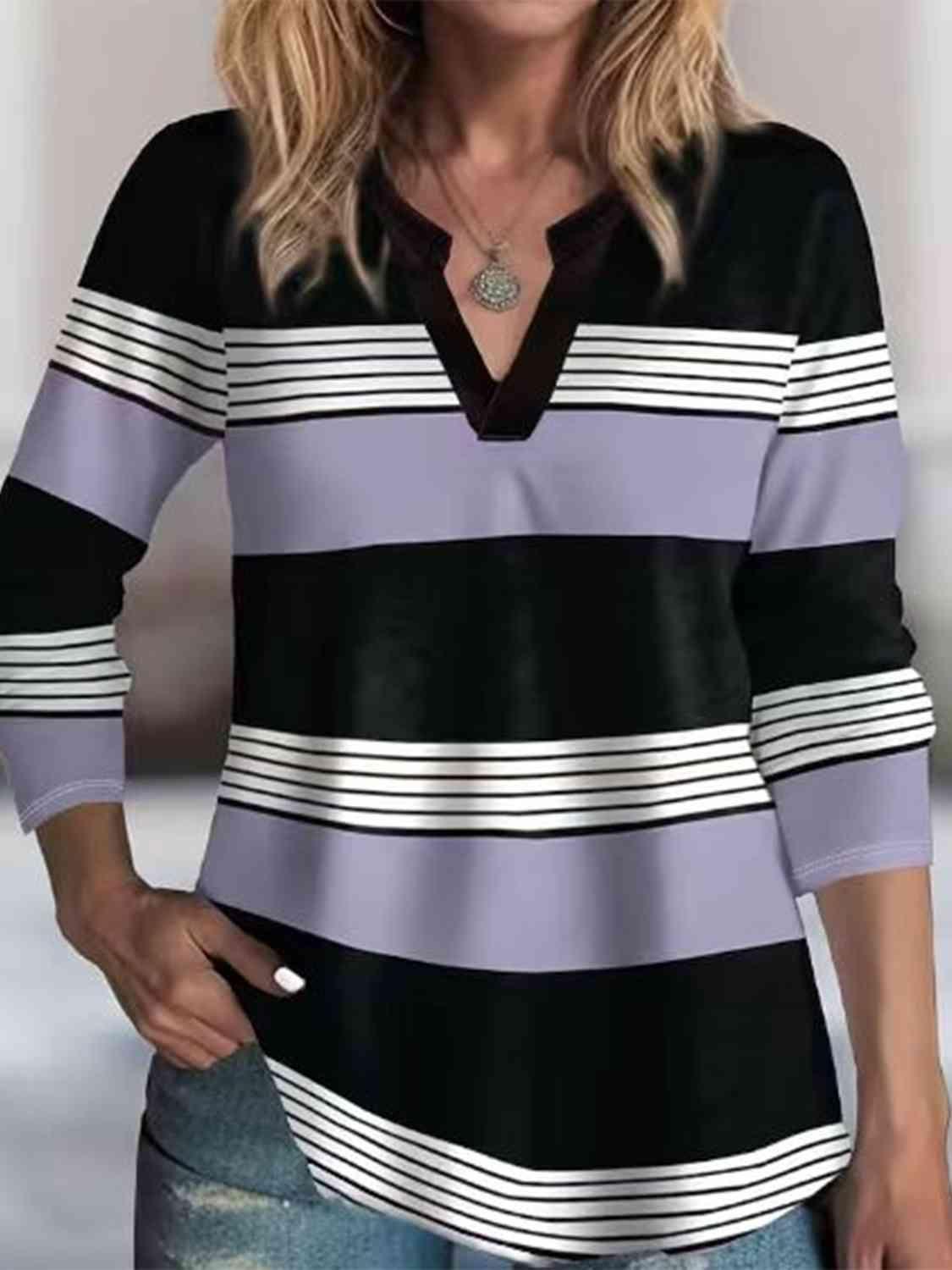 a woman wearing a black and white striped shirt