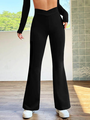 a woman in a black top and black pants