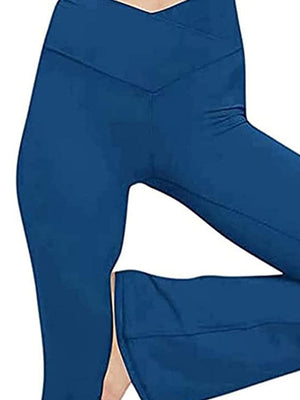 a woman in blue pants with her legs crossed