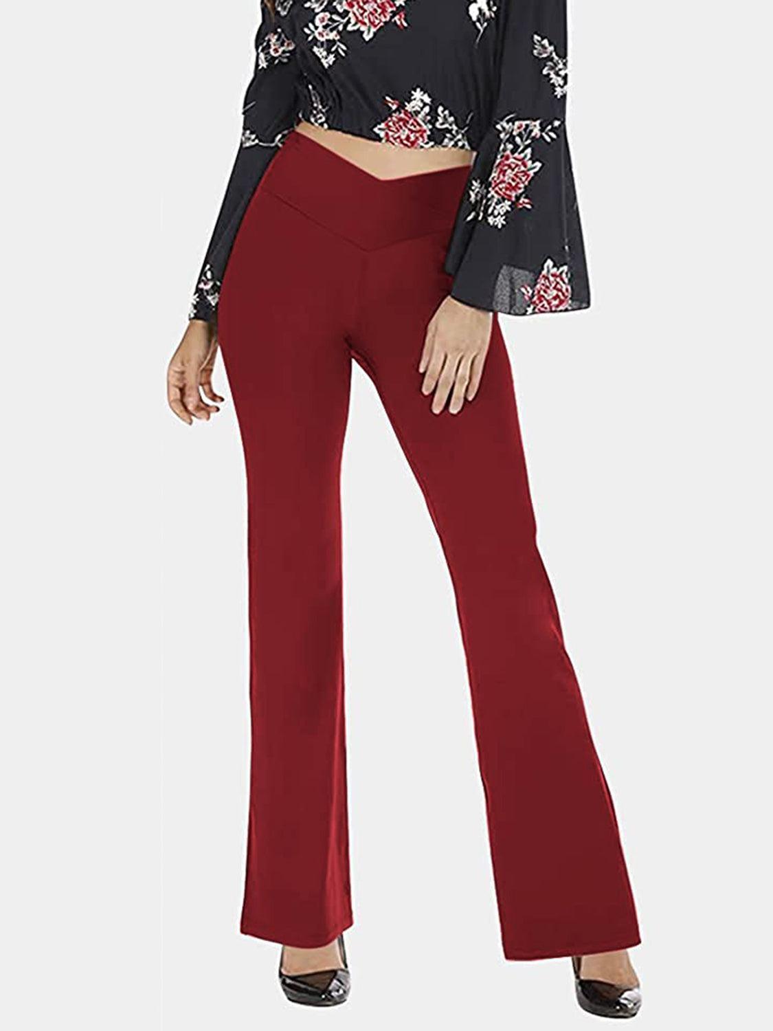 a woman in a cropped top and red pants