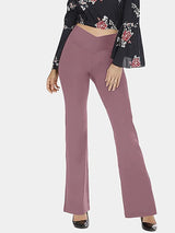 a woman in a black top and pink pants