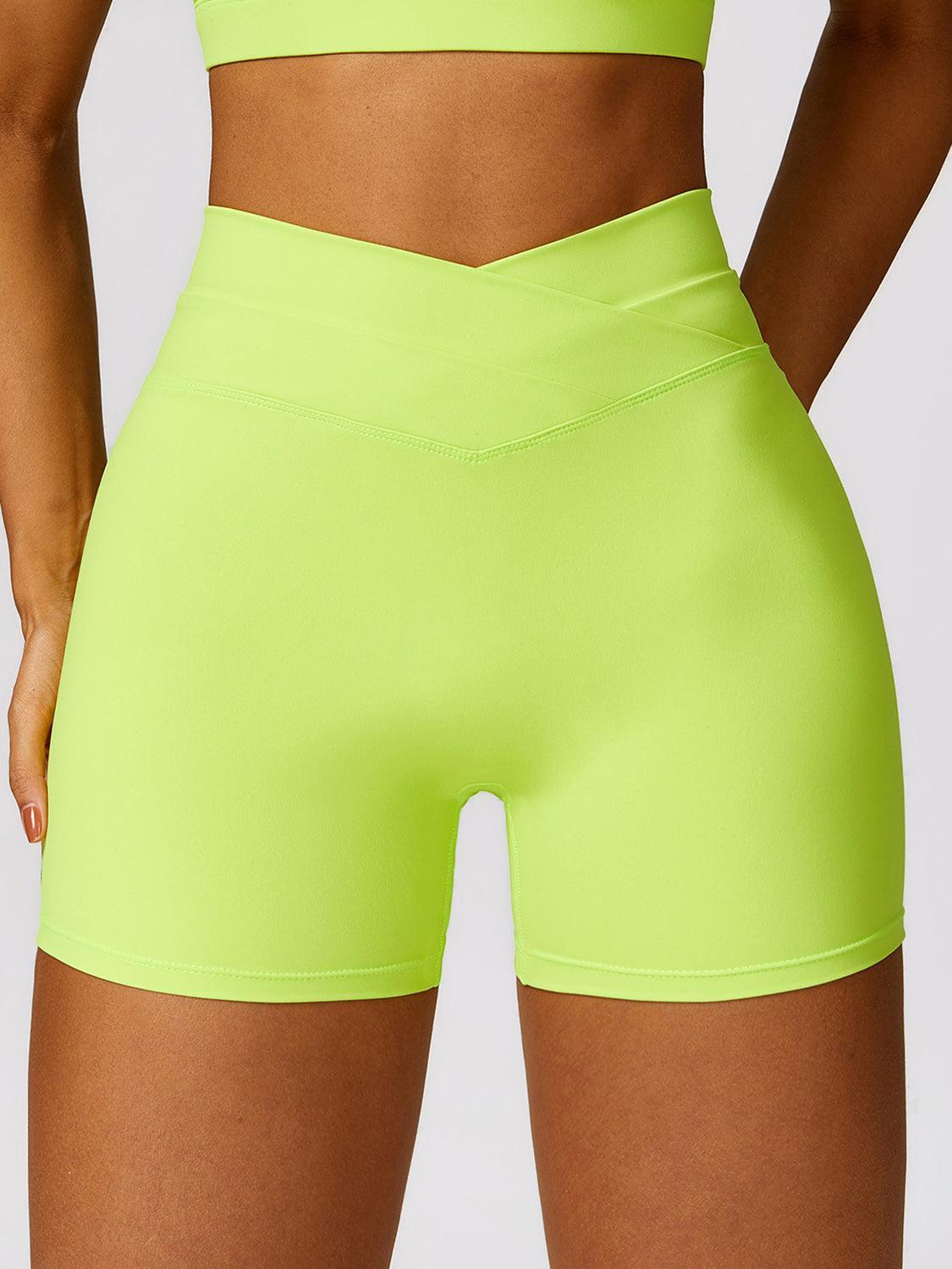 a woman in a neon green sports bra top and shorts