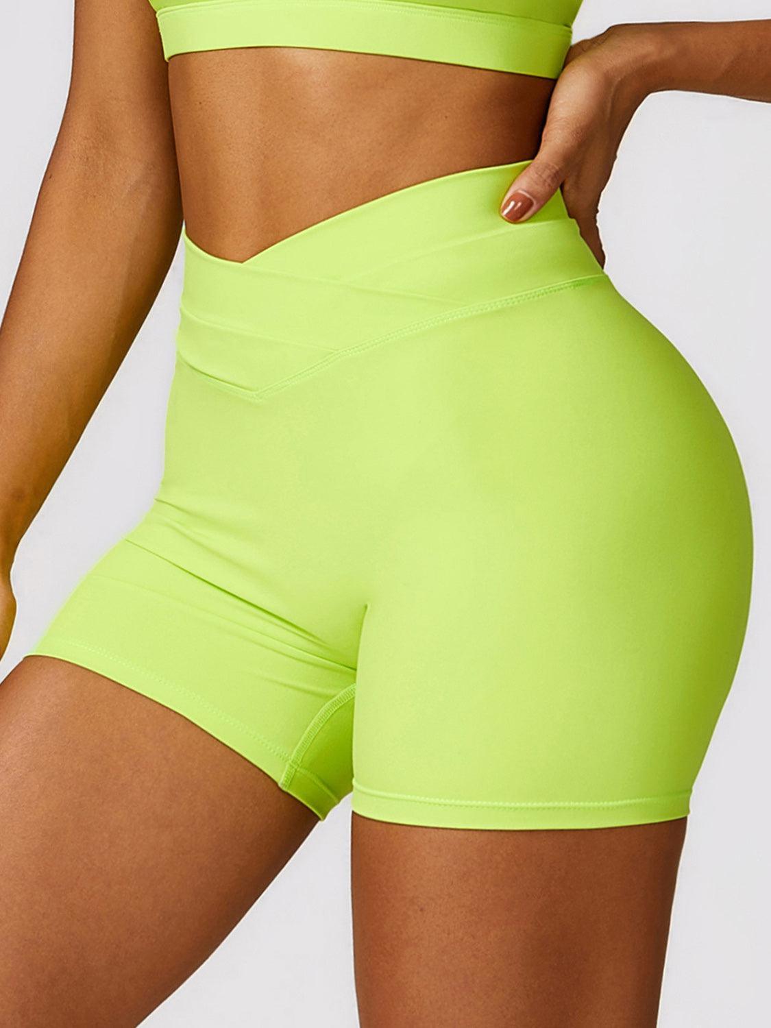 a woman in neon green shorts and a bra top