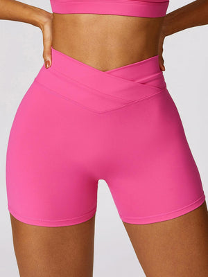 a woman in a pink sports bra top and shorts