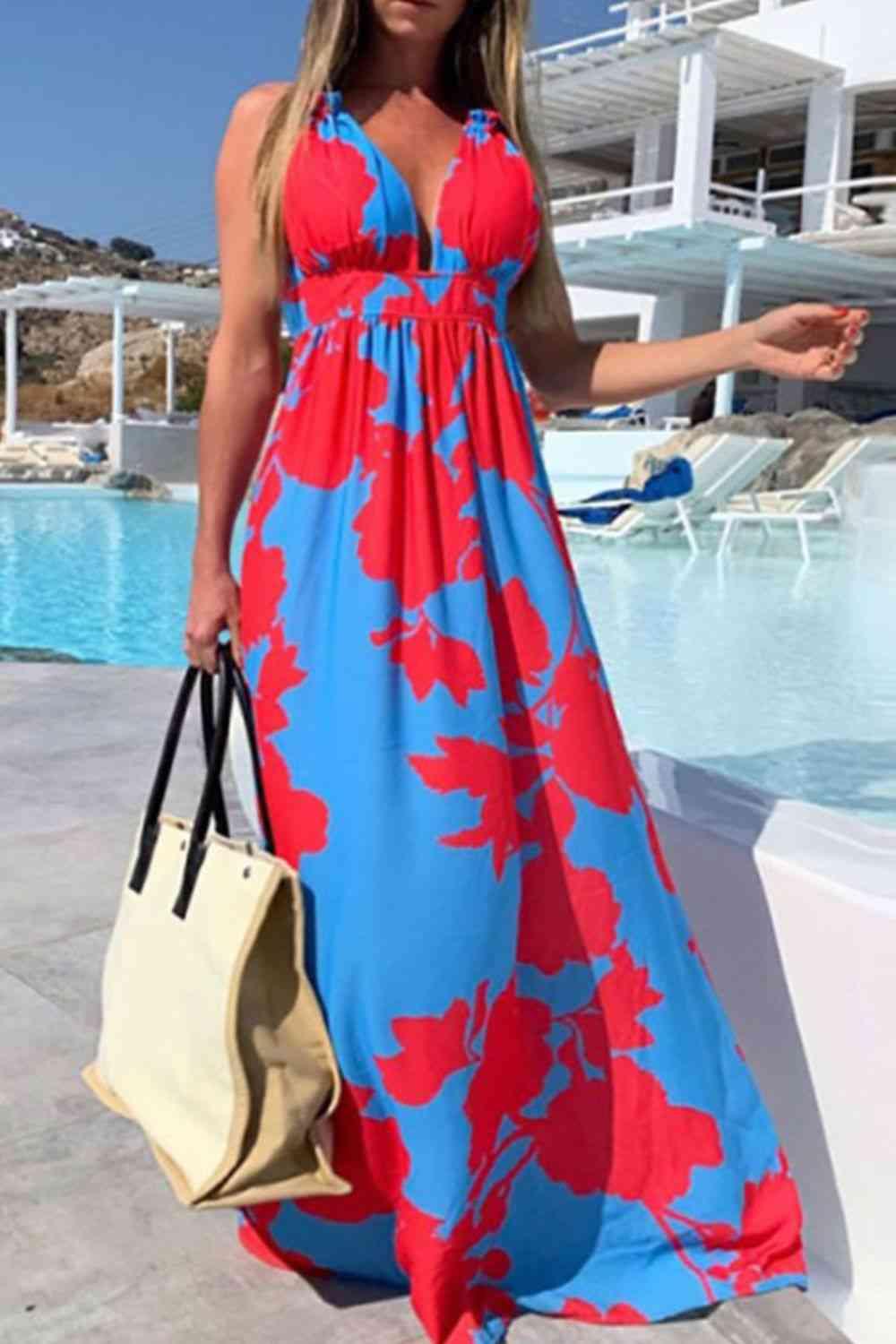 a woman in a blue and red dress standing next to a pool