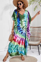 a woman wearing a tie - dyed dress and hat