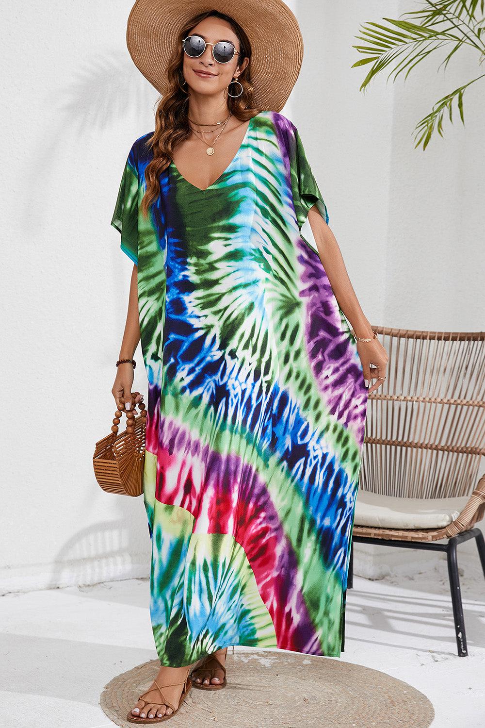 a woman wearing a tie dye dress and hat