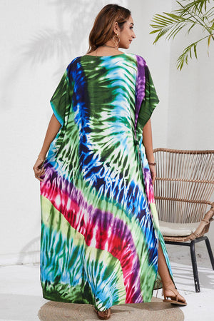 a woman in a colorful tie dye dress