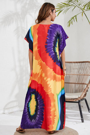 a woman wearing a colorful tie dye dress