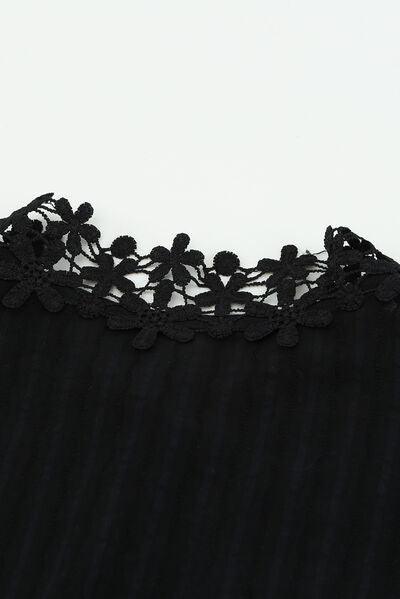 a close up of a black shirt with a lace on it