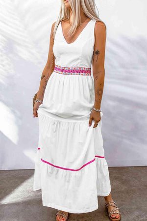 a woman wearing a white dress with pink trim