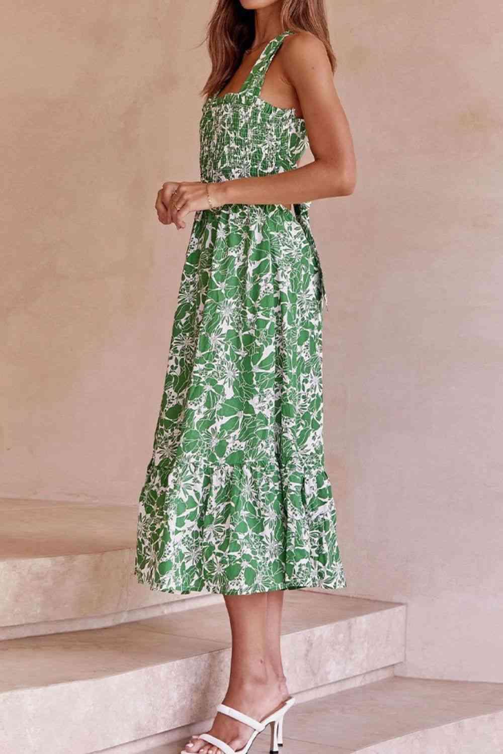 a woman in a green dress standing on steps