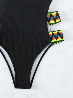 a woman's swimsuit with a pair of clips attached to it