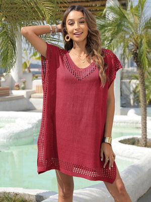 a woman standing in front of a pool wearing a red dress