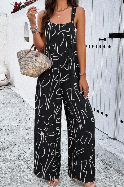 a woman in a black and white jumpsuit holding a straw bag