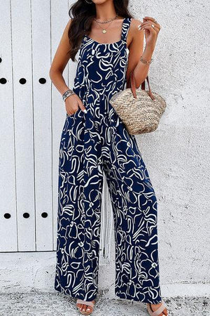 a woman wearing a blue and white patterned jumpsuit