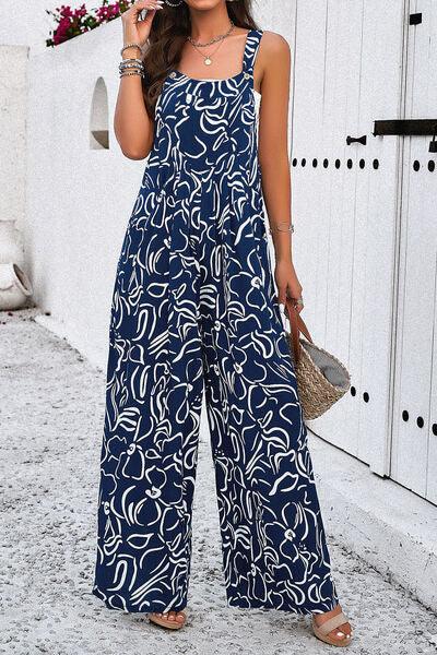 a woman in a blue and white jumpsuit talking on a cell phone