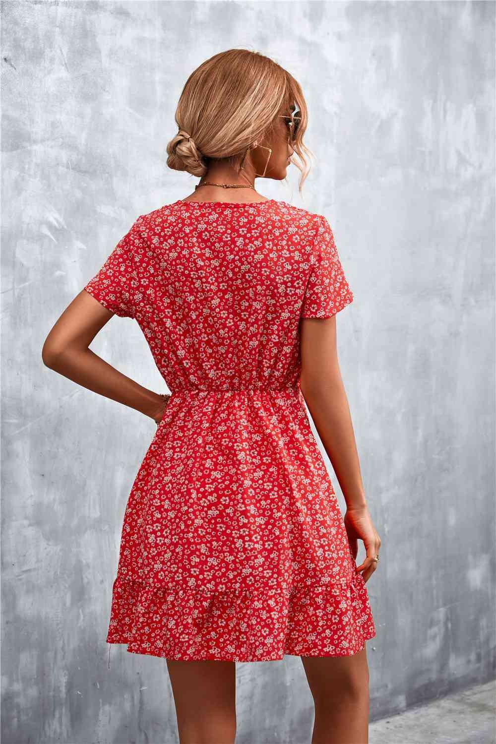a woman in a red floral print dress
