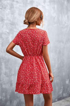 a woman in a red floral print dress